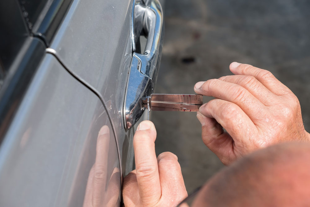 Automotive locksmith unlocking a car door in Houston TX